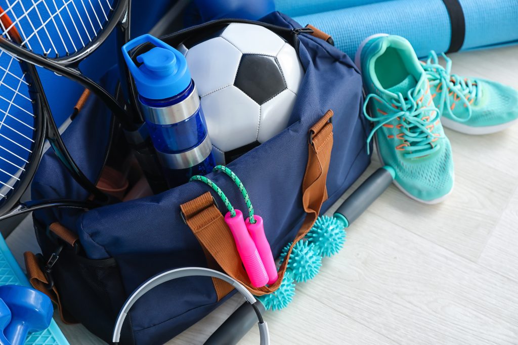 Set of sport equipment on floor near color wall